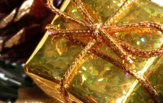Gift box with gold wrapping paper and twine.