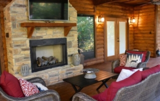 Staves & Steel Ranch deck with fireplace and furniture.