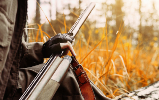 Close up of hunter with a rifle.