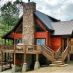 One of Beavers Bend's large two-story lodges with stone fireplace in front.