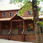 front view of the large two-story Four Sisters Lodge