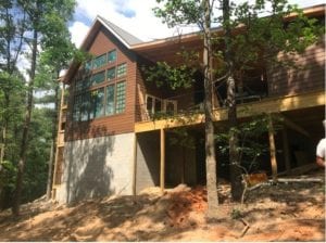 Exterior photo of the two-story lodge, featuring a wood frame and deck.
