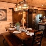 Kitchen which has dark wood cabinets and large island with stainless steel appliances.