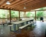 The outdoor patio with a long picnic table.