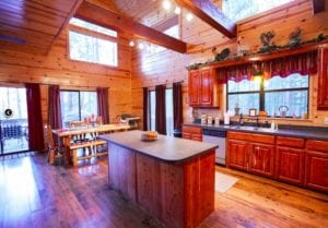 A photo of the large kitchen featuring wood floors and cabinets.