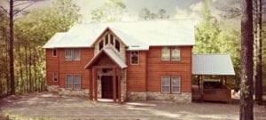 The two-story wood frame lodge surrounded by tall pine trees.