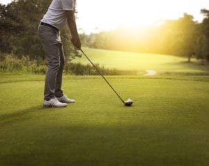 Man hitting golf ball, Oklahoma golf courses