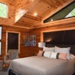 Paneled master bedroom with king bed.