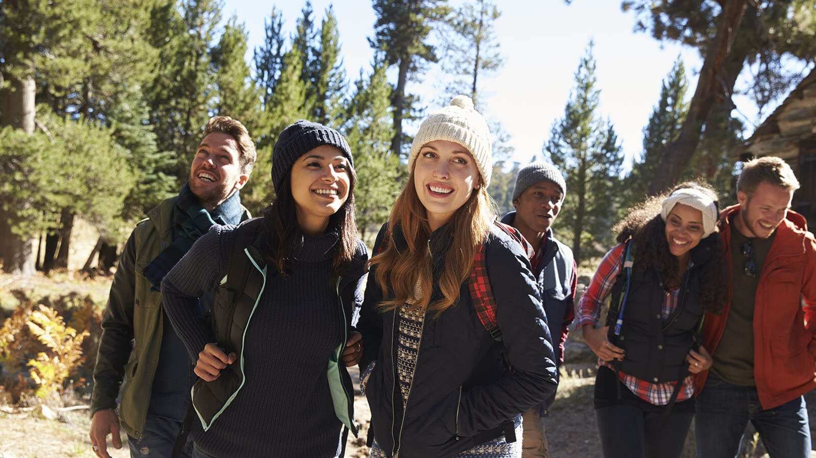 Group of friends in fall coats and hats.