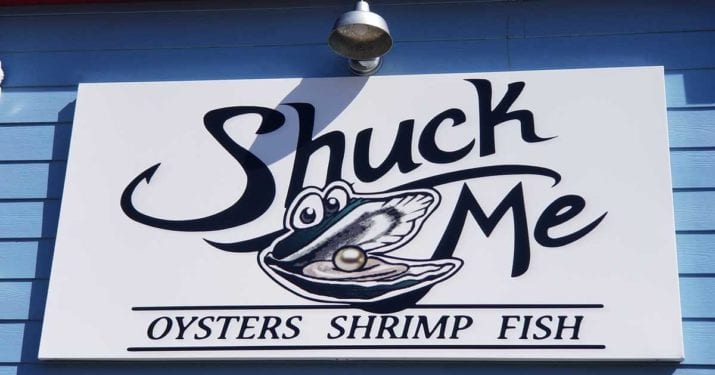 Shuck Me sign. Text: Shuck Me, oysters, shrimp, fish.