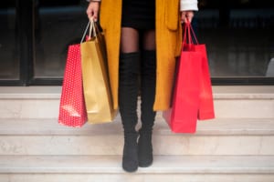 Woman holding shopping bags outside Oklahoma Boutiques
