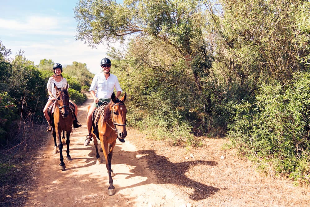 A photo of a group horseback riding in Broken Bow.