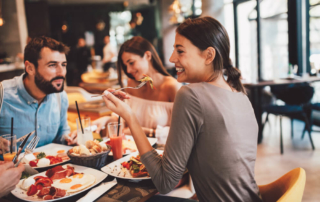 A group of people eating at one of the various restaurants in Broken Bow, OK.