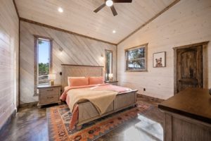 Relax after a hiking adventure in a Broken Bow cabin with a cozy bedroom like this one.