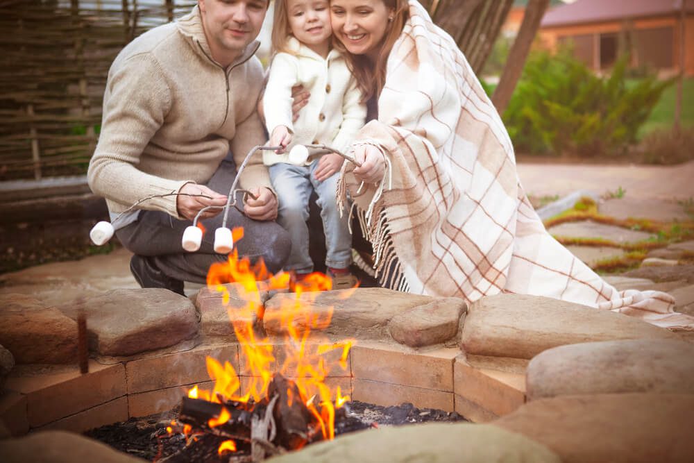 A family making s'mores, one of the must-do things to din Broken Bow, Oklahoma.