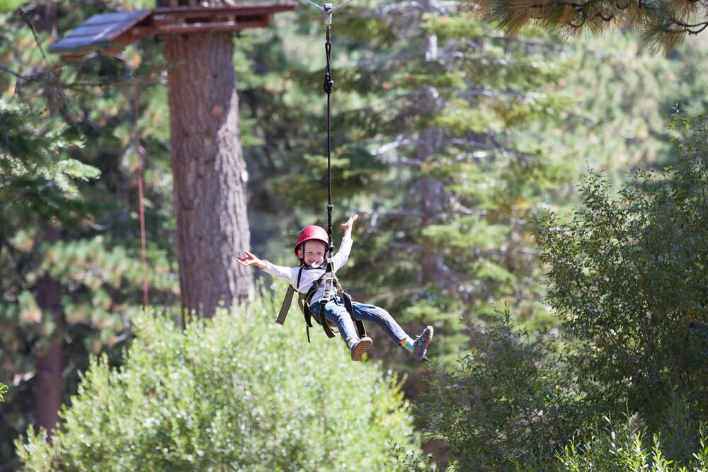 A kid ziplining on his Oklahoma spring break getaway.