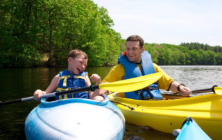 A father and son kayaking during an Oklahoma summer vacation.