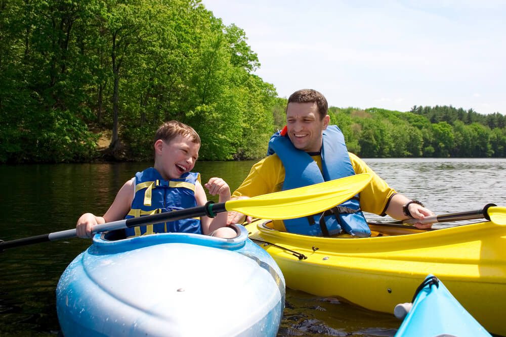 A father and son kayaking during an Oklahoma summer vacation.