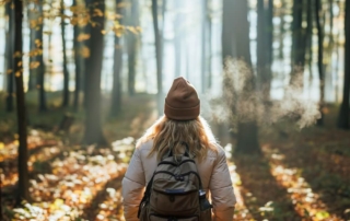 A woman hiking on a Broken Bow trail during an Oklahoma winter vacation.