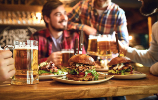 A group with food and beer at one of the top Hochatown restaurants.