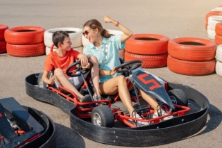 A mom and child riding go karts, one of the best things to do in Hochatown with kids.