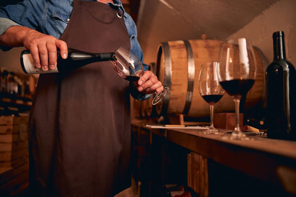 A person pouring wine at a Broken Bow winery.