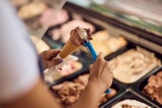 A person scooping ice cream at a Hochatown shop.