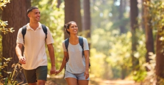 A couple hiking on one of their romantic getaways in Hochatown, Oklahoma.