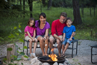 A family enjoying a campfire at their Hochatown cabin rental.