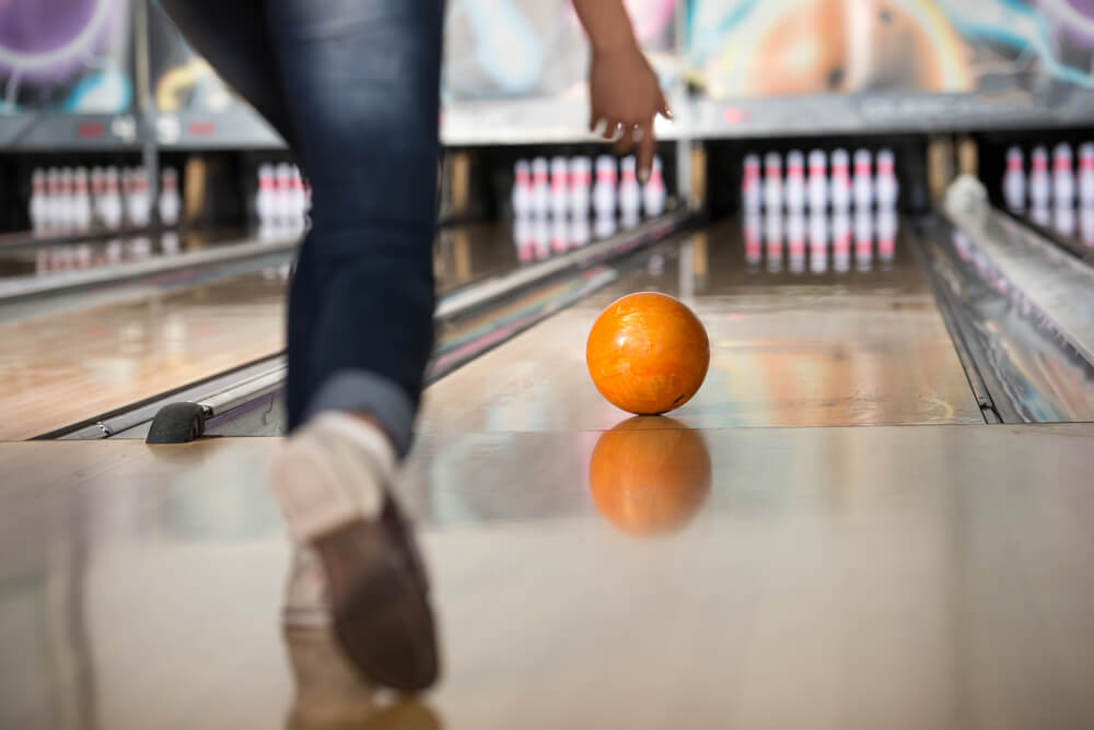 A person bowling, one of the best indoor activities in Broken Bow.