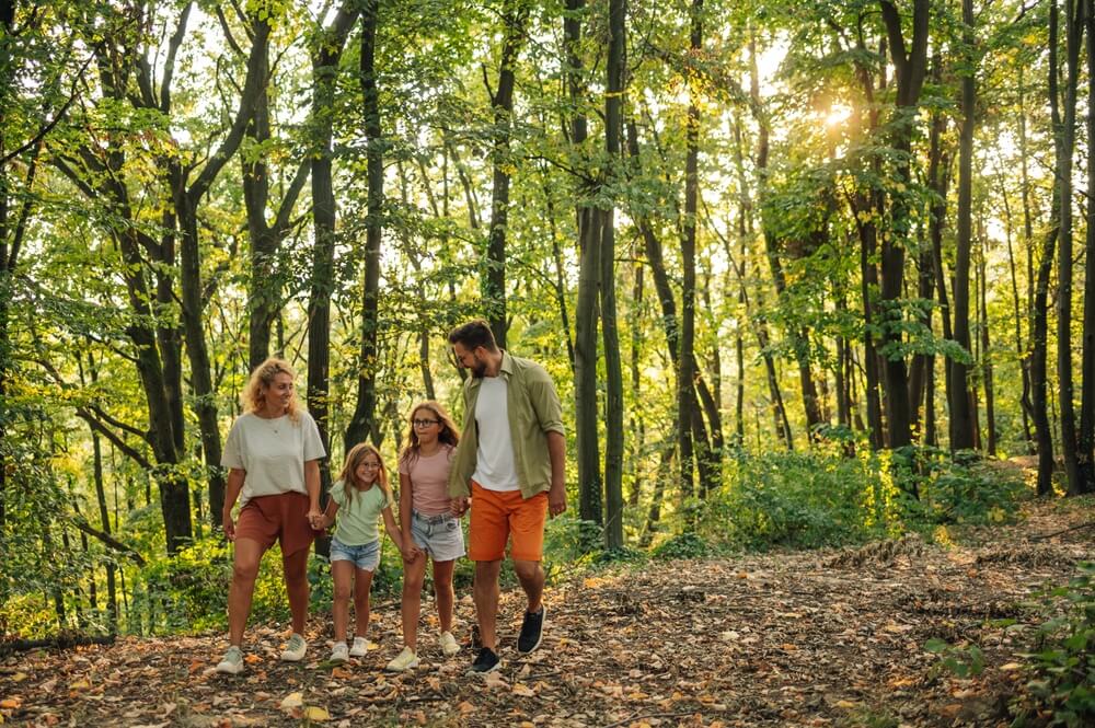 A family hiking on their Oklahoma summer vacation in Hochatown.