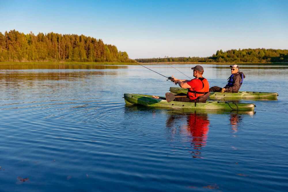 People kayak fishing on Broken Bow lake.